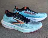 Zwei hellblaue Laufschuhe, Brooks Hyperion 3, mit orangefarbenen Akzenten und dem Brooks-Logo.