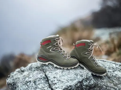 Grüne Lowa Renegade Wanderschuhe auf Felsen, bereit für den Test im Gelände.