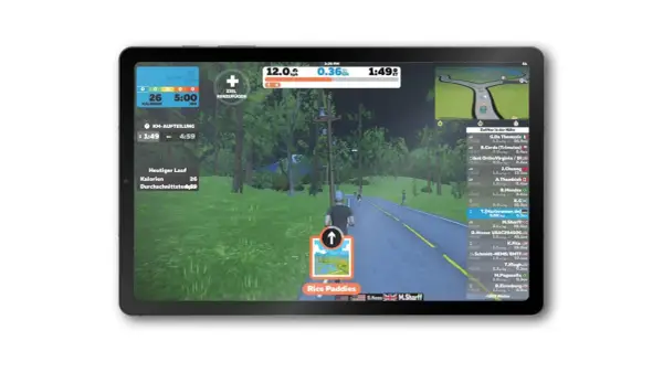 Ein Läufer nimmt an einem virtuellen Lauf teil, mit einer virtuellen Landschaft und Ranglisten auf dem Bildschirm.